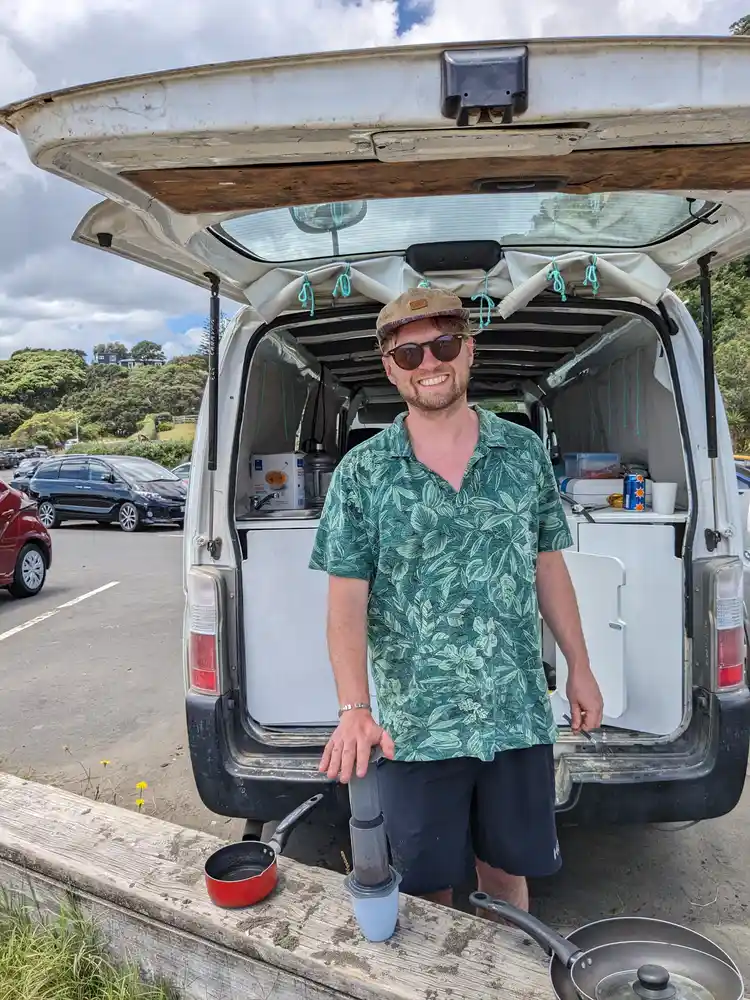 Ross Deacon cooking at the back of his Toyota Hiace campervan